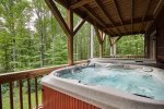 Soaking in this hot tub under the covered porch is a great way to relax.
